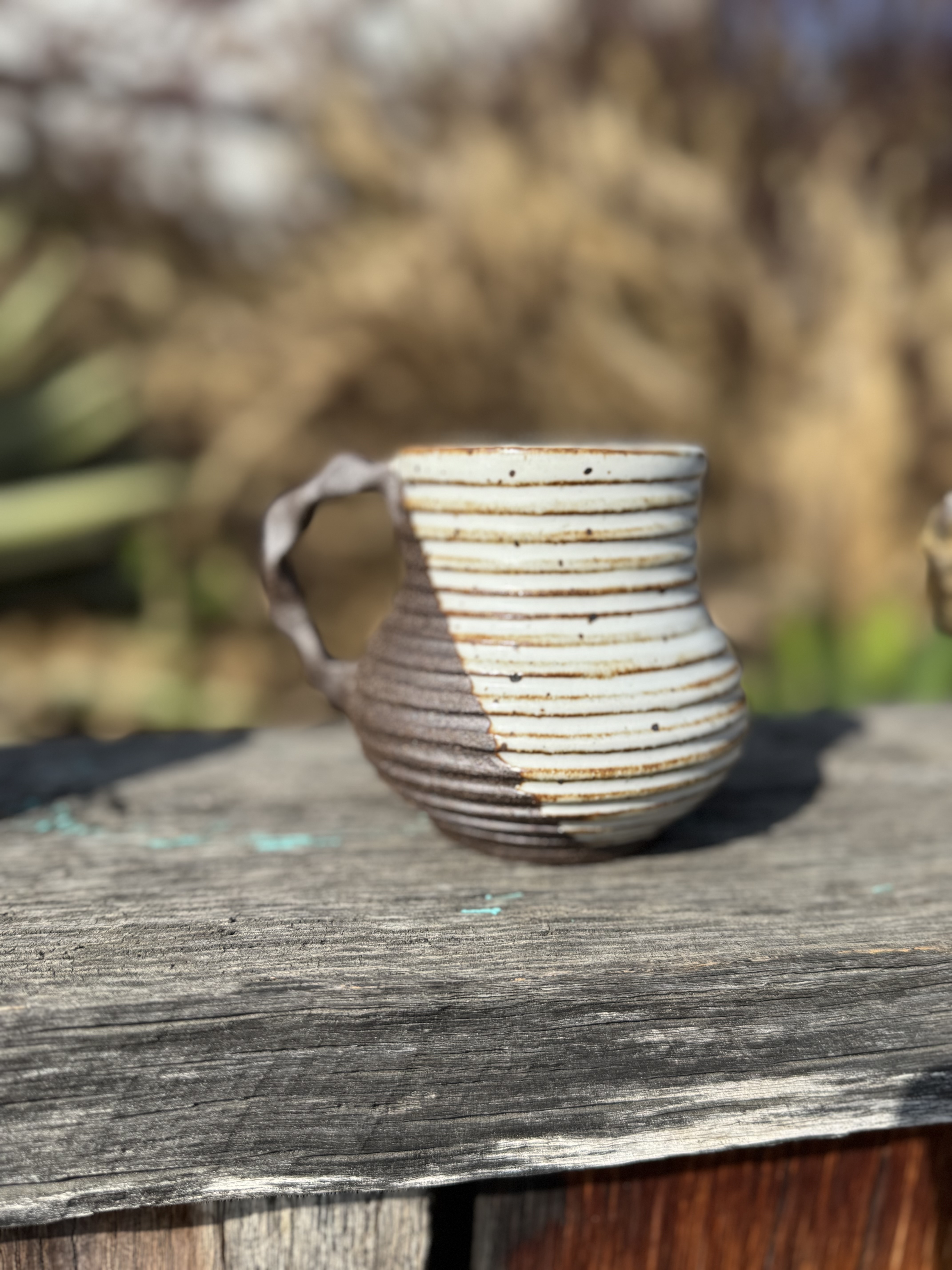 Handmade ceramic mug with ribbed texture