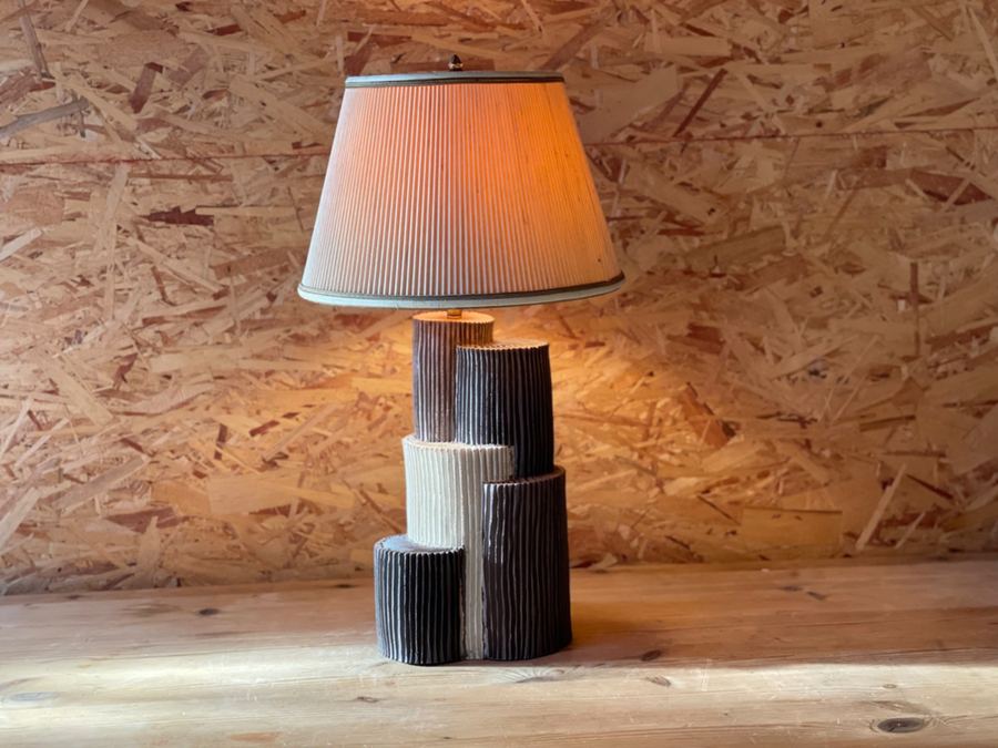 Ribbed cylinder totem lamp front glowing warm