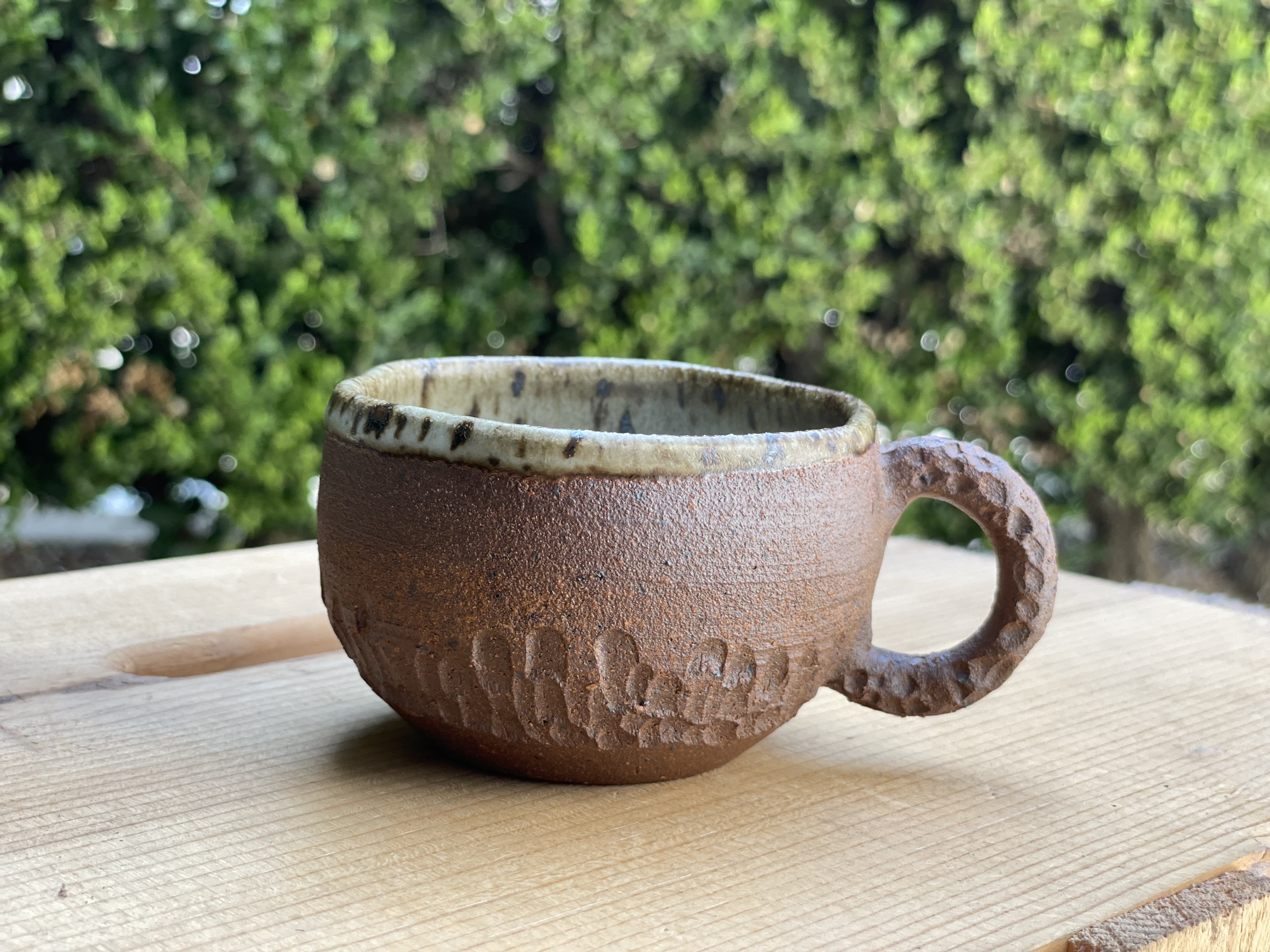 Handmade ceramic mug with textured glaze